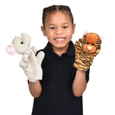 A young boy holding two party animal hand puppets