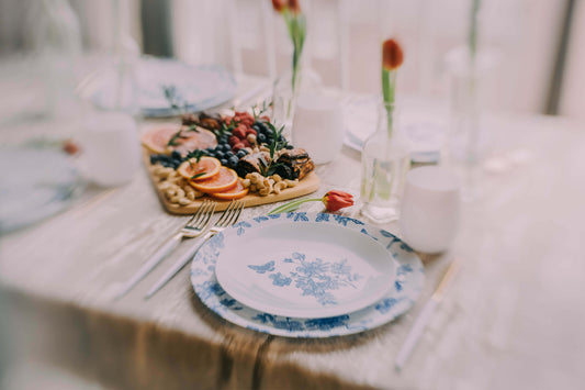 Image of a refined table setting with elegant plastic plates and a floral-themed table runner adding visual interest.